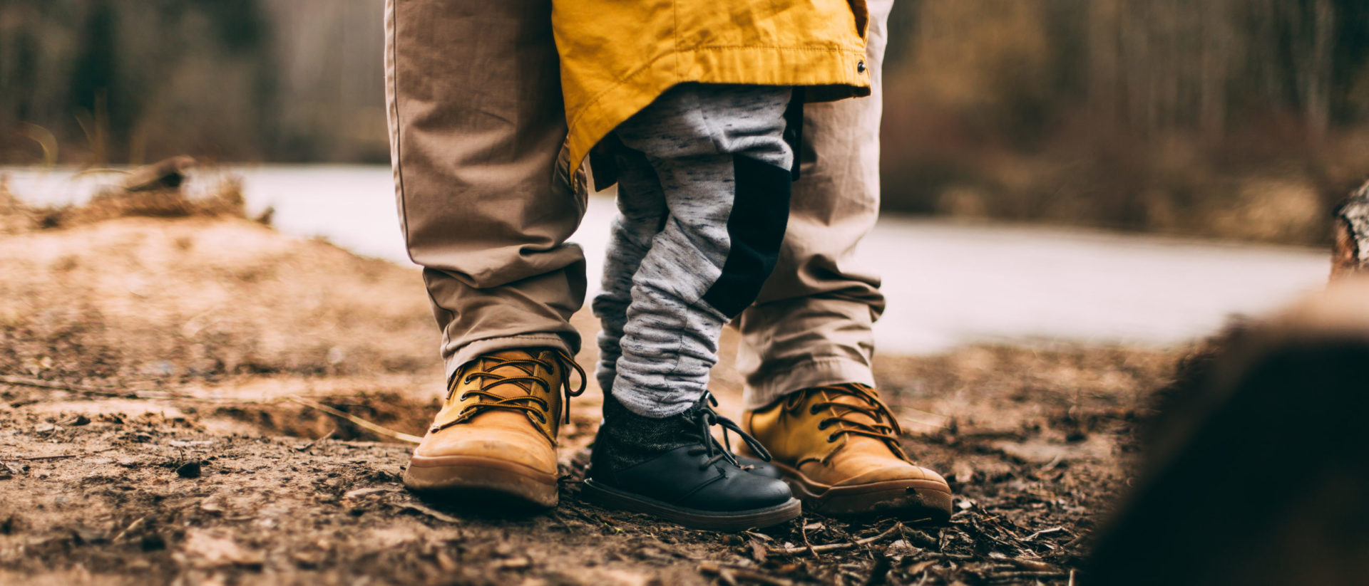 child and parent feet in woods